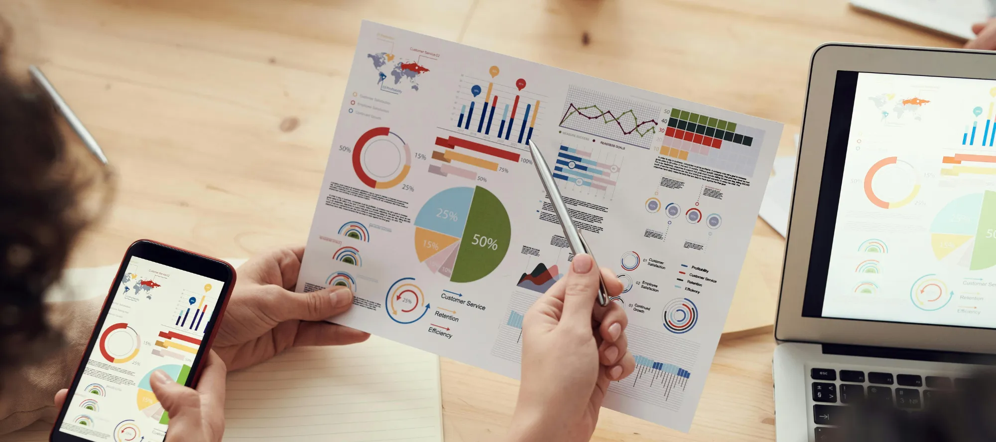 Verschiedene Grafiken auf Papier, Smartphone und Computer